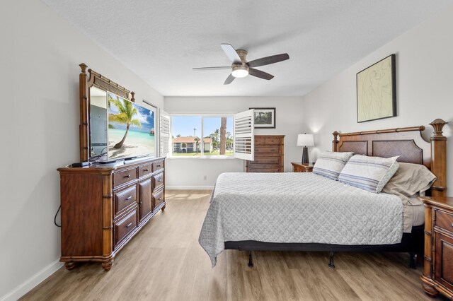 3561 Pine Tree Ct Unit A-2, Greenacres, FL 33463 - bedroom with light wood-type flooring, baseboards, and a ceiling fan