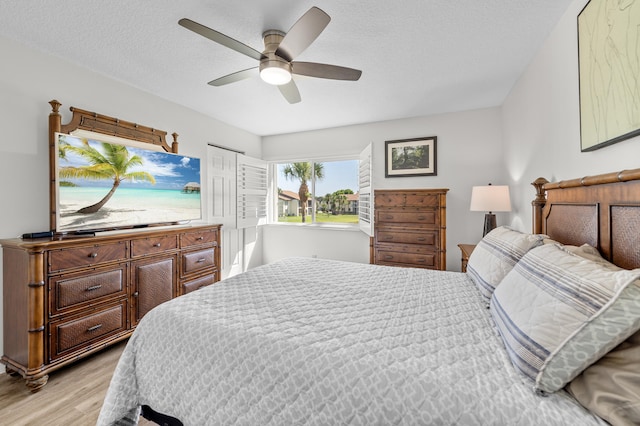 3561 Pine Tree Ct Unit A-2, Greenacres, FL 33463 - bedroom featuring light wood-type flooring, a ceiling fan, and a textured ceiling