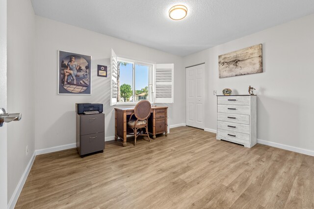 3561 Pine Tree Ct Unit A-2, Greenacres, FL 33463 - home office with light wood-type flooring, baseboards, and a textured ceiling