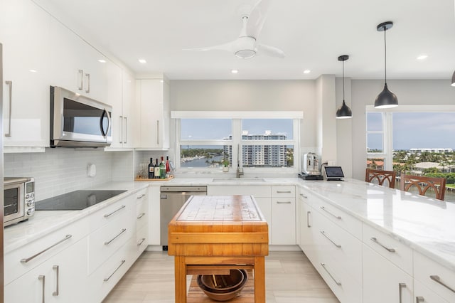 400 Seasage Dr Unit 805, Delray Beach, FL 33483 - kitchen featuring stainless steel appliances, plenty of natural light, backsplash, and recessed lighting
