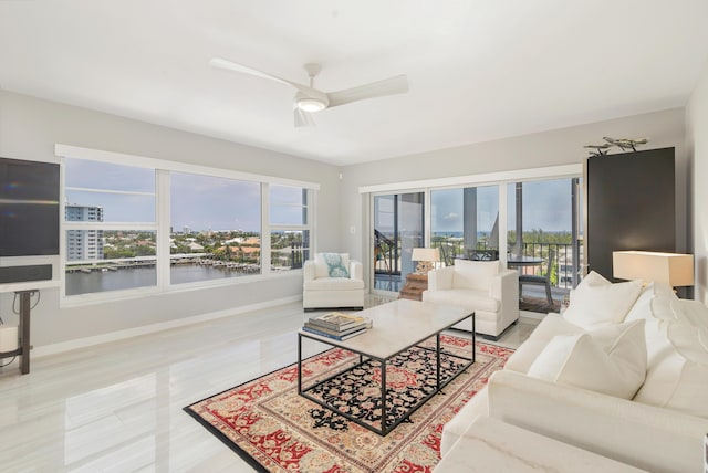 400 Seasage Dr Unit 805, Delray Beach, FL 33483 - living room featuring a ceiling fan, baseboards, a water view, and wood finished floors