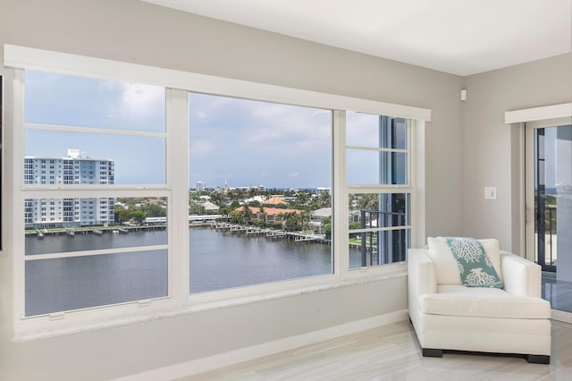 400 Seasage Dr Unit 805, Delray Beach, FL 33483 - sitting room featuring a water view, baseboards, and wood finished floors