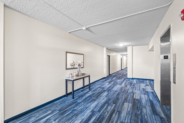 55 SW 2nd Ave Unit 405G, Boca Raton, FL 33432 - corridor with wood finished floors, a textured ceiling, baseboards, and elevator