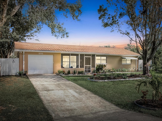 251 Grape Rd NW, Lake Placid, FL 33852 - single story home featuring a garage, driveway, stucco siding, and a sunroom