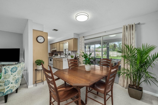 251 Grape Rd NW, Lake Placid, FL 33852 - dining room with light colored carpet, baseboards, and a textured ceiling