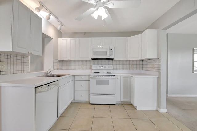 kitchen with white appliances, a sink, ceiling fan, and tasteful backsplash