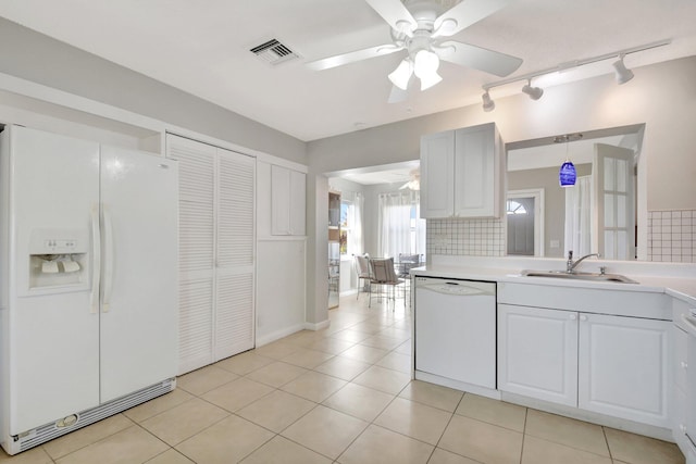 kitchen featuring white appliances, a ceiling fan, a sink, track lighting, and light countertops