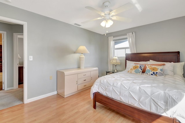 bedroom with light wood-style flooring, baseboards, and ceiling fan