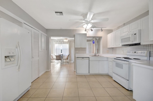 kitchen with white appliances, ceiling fan, backsplash, and light countertops