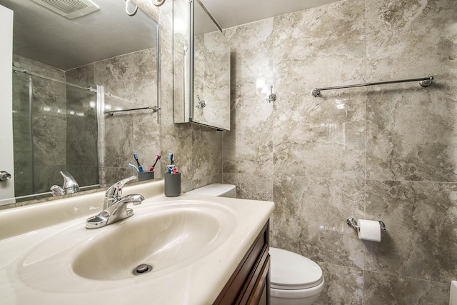 50 SE 12th St Unit 2640, Boca Raton, FL 33432 - bathroom featuring tile walls, toilet, a shower stall, and vanity