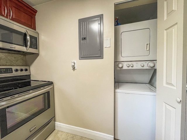 50 SE 12th St Unit 2640, Boca Raton, FL 33432 - clothes washing area featuring stacked washer / dryer, electric panel, and baseboards
