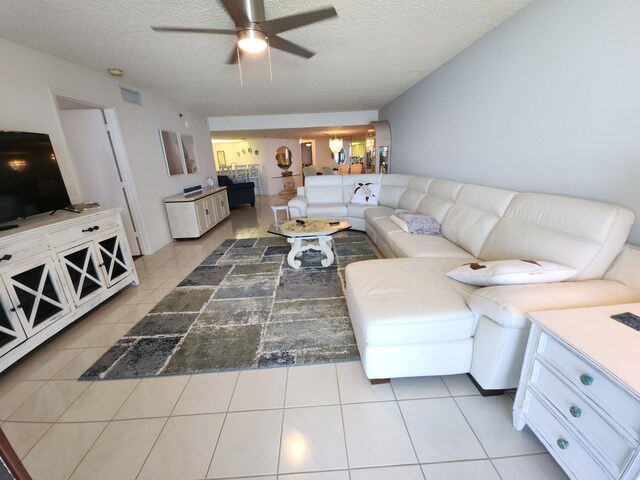 3120 N A1A Unit 1004, Hutchinson Island, FL 34949 - living area with ceiling fan and a textured ceiling
