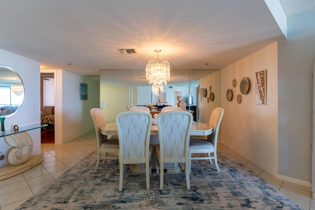 dining area featuring light tile patterned floors and a chandelier