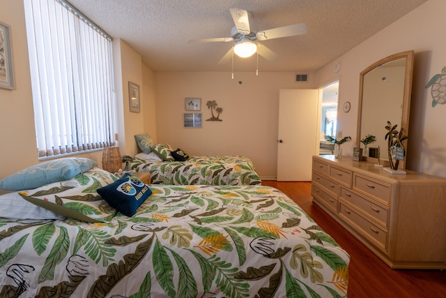 3120 N A1A Unit 1004, Hutchinson Island, FL 34949 - bedroom with wood finished floors, a textured ceiling, and ceiling fan