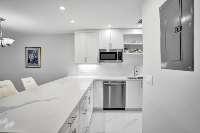 kitchen featuring stainless steel appliances, electric panel, a sink, light marble finish flooring, and open shelves