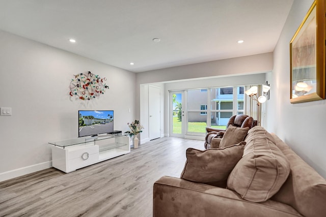 living room featuring wood finished floors, baseboards, and recessed lighting
