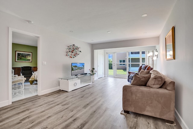 living area featuring wood finished floors, baseboards, and recessed lighting