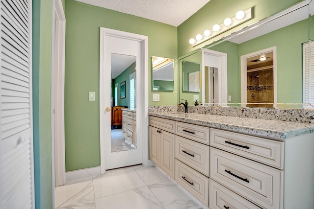 bathroom featuring vanity and marble finish floors