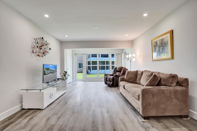living room featuring wood finished floors, baseboards, and recessed lighting