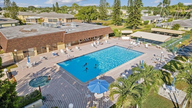 community pool featuring a patio area and fence