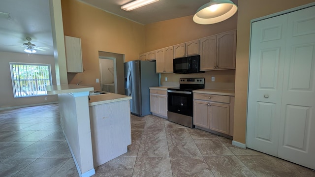 1500 SW Bermel Ave, Port Saint Lucie, FL 34953 - kitchen featuring appliances with stainless steel finishes, light countertops, a sink, a ceiling fan, and a peninsula