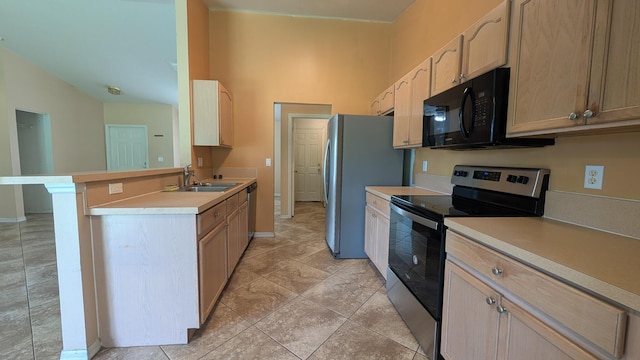 1500 SW Bermel Ave, Port Saint Lucie, FL 34953 - kitchen featuring appliances with stainless steel finishes, a sink, light countertops, a peninsula, and baseboards