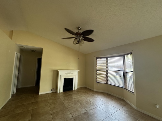 1433 SW San Esteban Ave, Port Saint Lucie, FL 34953 - unfurnished living room with vaulted ceiling, tile patterned floors, a ceiling fan, a fireplace, and baseboards