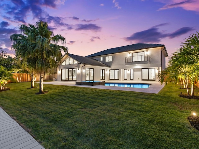 8 Leeward Cir, Tequesta, FL 33469 - back of house featuring a balcony, a patio area, and a pool with connected hot tub