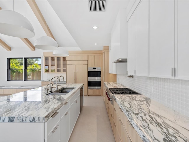 8 Leeward Cir, Tequesta, FL 33469 - kitchen featuring stainless steel appliances, a sink, decorative backsplash, light stone countertops, and recessed lighting