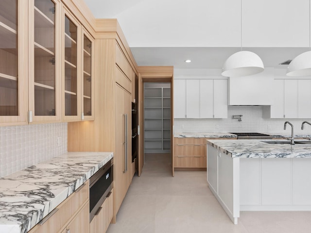 8 Leeward Cir, Tequesta, FL 33469 - kitchen with a sink, backsplash, modern cabinets, light stone counters, and recessed lighting