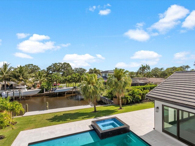 8 Leeward Cir, Tequesta, FL 33469 - view of pool with a lawn, a water view, a patio, and a pool with connected hot tub