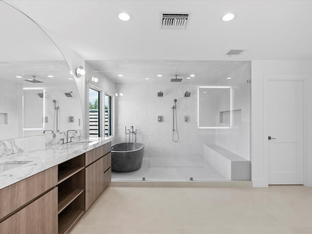 8 Leeward Cir, Tequesta, FL 33469 - bathroom featuring recessed lighting, walk in shower, double vanity, and a freestanding tub