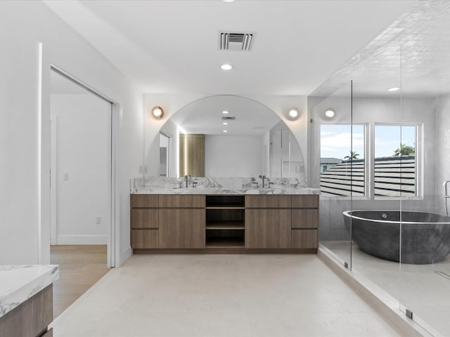 8 Leeward Cir, Tequesta, FL 33469 - bathroom with double vanity and a freestanding bath