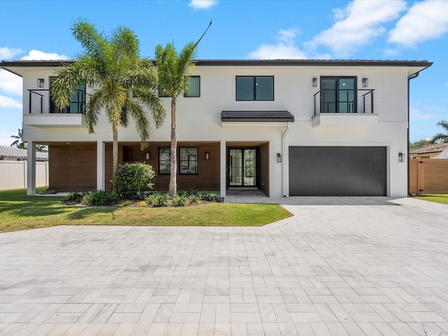 8 Leeward Cir, Tequesta, FL 33469 - view of front of property with a balcony, a garage, and decorative driveway