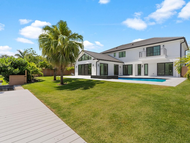 8 Leeward Cir, Tequesta, FL 33469 - back of house featuring a balcony and an outdoor pool