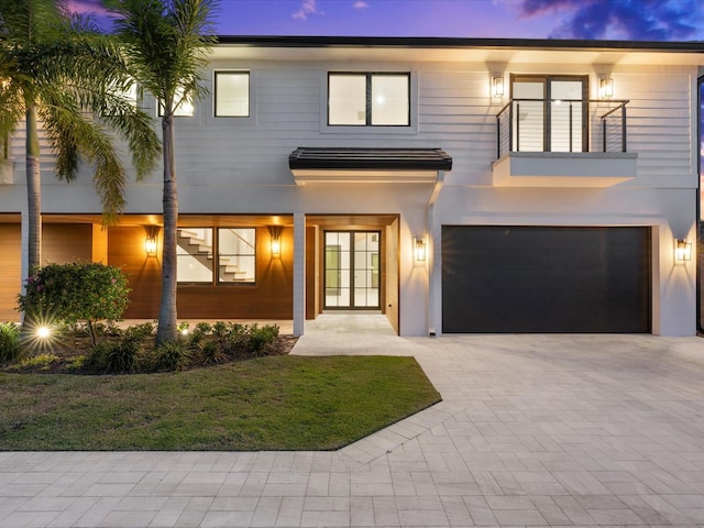 8 Leeward Cir, Tequesta, FL 33469 - contemporary house featuring french doors, a garage, a balcony, a yard, and driveway