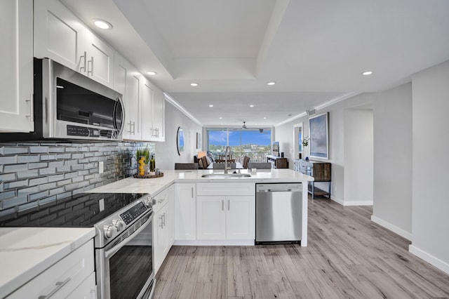 3100 S Ocean Blvd Unit 620, Highland Beach, FL 33487 - kitchen with stainless steel appliances, a sink, decorative backsplash, a peninsula, and recessed lighting