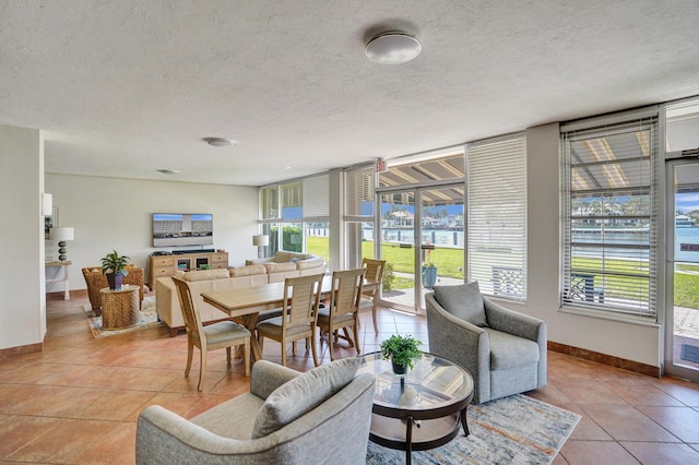 3100 S Ocean Blvd Unit 620, Highland Beach, FL 33487 - dining room with light tile patterned floors, baseboards, a textured ceiling, and floor to ceiling windows