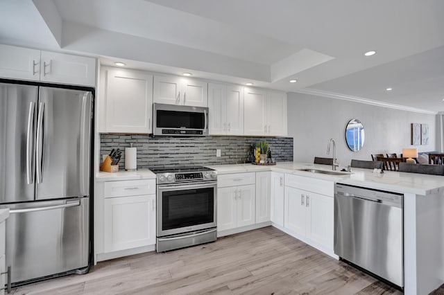 3100 S Ocean Blvd Unit 620, Highland Beach, FL 33487 - kitchen featuring stainless steel appliances, a sink, a peninsula, tasteful backsplash, and white cabinets