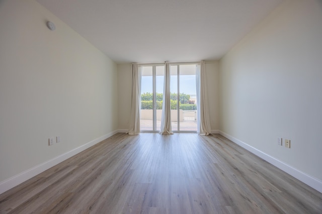 350 N Federal Hwy SE Unit 506, Boynton Beach, FL 33435 - spare room with wood finished floors, baseboards, floor to ceiling windows, and a smoke detector