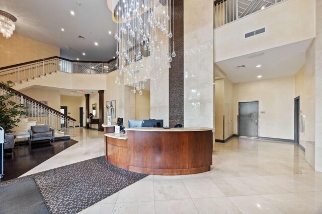 350 N Federal Hwy SE Unit 506, Boynton Beach, FL 33435 - reception with a towering ceiling, a chandelier, stairs, and recessed lighting