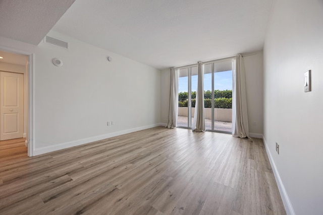350 N Federal Hwy SE Unit 506, Boynton Beach, FL 33435 - empty room featuring light wood-style floors, baseboards, and floor to ceiling windows