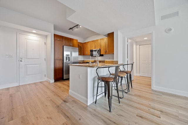 350 N Federal Hwy SE Unit 506, Boynton Beach, FL 33435 - kitchen featuring stainless steel appliances, a breakfast bar, light wood finished floors, a peninsula, and recessed lighting