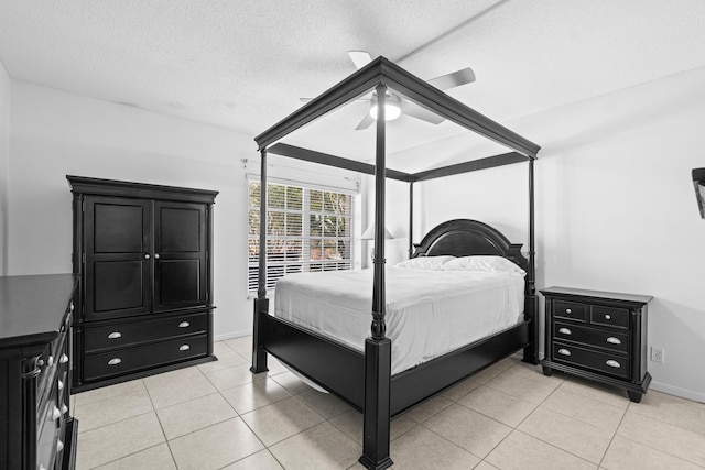 250 NE 20th St Unit 1220, Boca Raton, FL 33431 - bedroom with light tile patterned flooring, ceiling fan, baseboards, and a textured ceiling