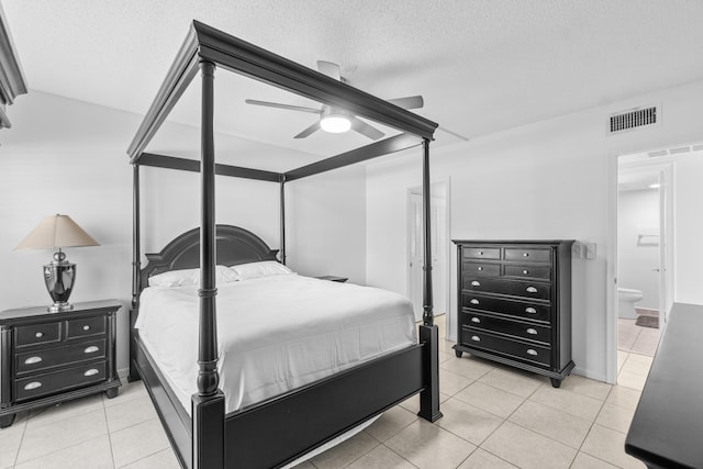 250 NE 20th St Unit 1220, Boca Raton, FL 33431 - bedroom featuring light tile patterned floors, a textured ceiling, ensuite bath, and ceiling fan