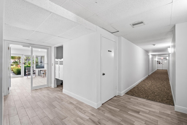 250 NE 20th St Unit 1220, Boca Raton, FL 33431 - corridor featuring light wood-style floors, a paneled ceiling, and baseboards