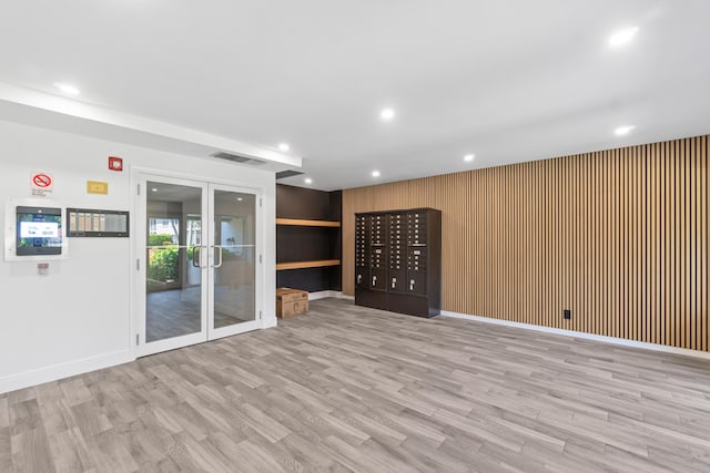 250 NE 20th St Unit 1220, Boca Raton, FL 33431 - unfurnished room with wood finished floors, mail area, recessed lighting, wooden walls, and french doors
