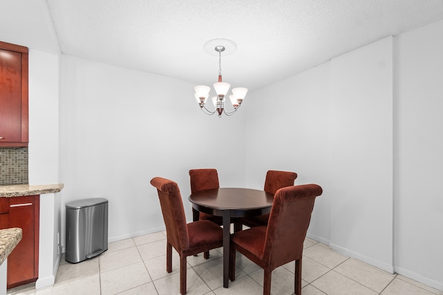 250 NE 20th St Unit 1220, Boca Raton, FL 33431 - dining area featuring a chandelier, light tile patterned floors, and baseboards