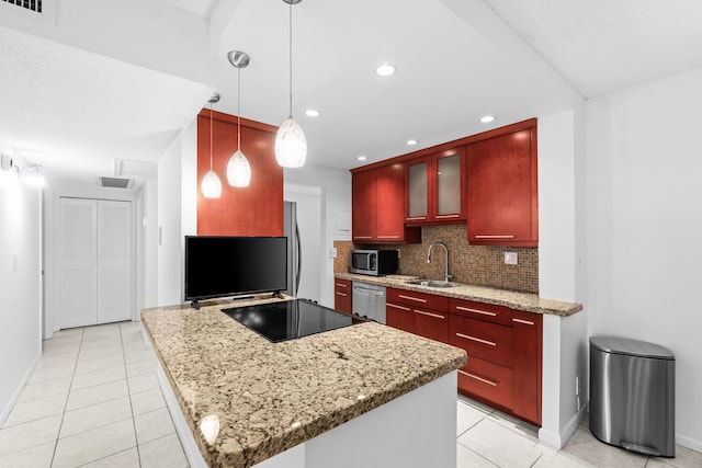 250 NE 20th St Unit 1220, Boca Raton, FL 33431 - kitchen with a sink, appliances with stainless steel finishes, dark brown cabinets, light tile patterned floors, and baseboards