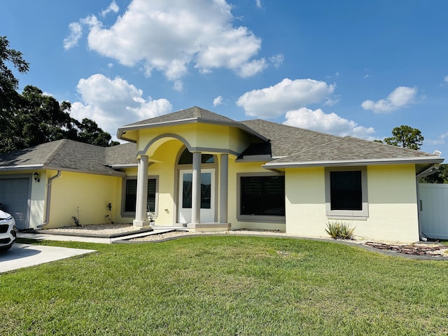 1601 SW California Blvd, Port Saint Lucie, FL 34953 - view of front of property with roof with shingles, a front lawn, a garage, and stucco siding